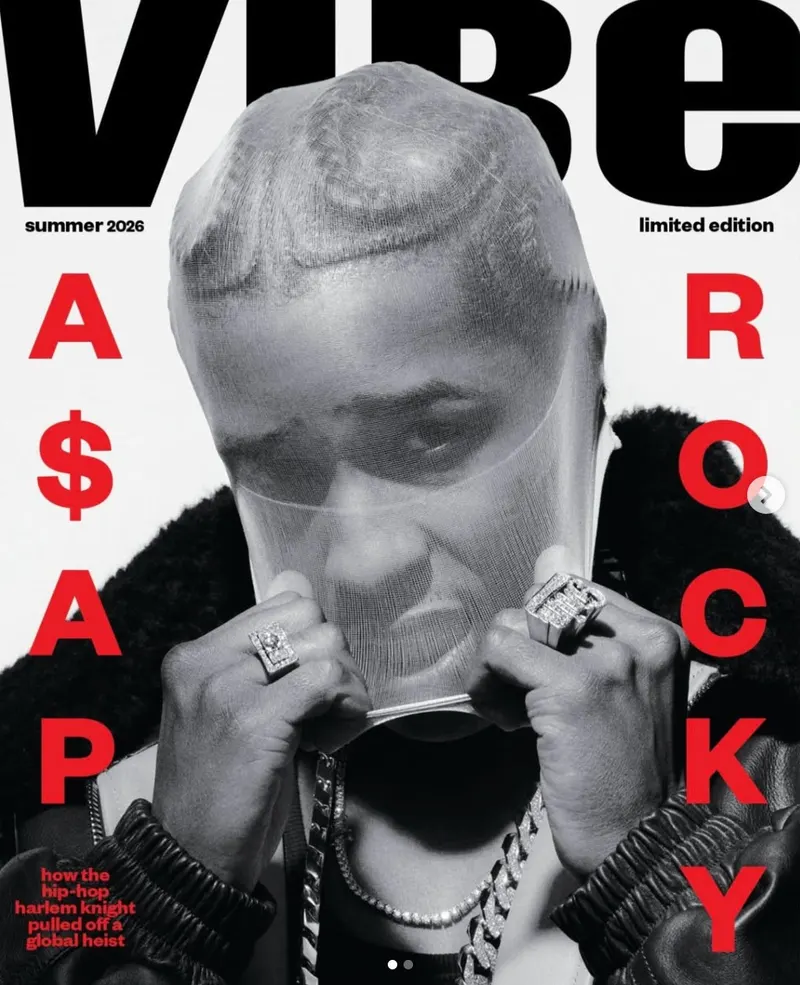 Magazine cover featuring a black and white portrait photograph of a figure wearing a sheer mesh cap, puffer jacket, and heavy jewelry.